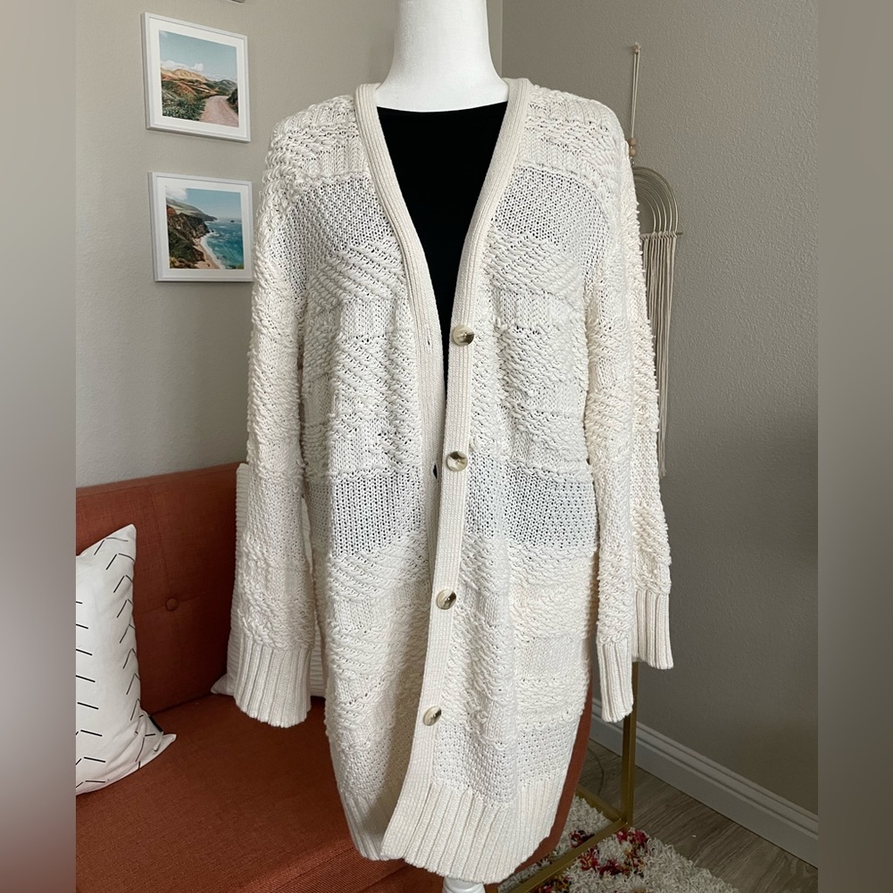 Cream, thigh length Amaryllis cardigan with bell sleeve.